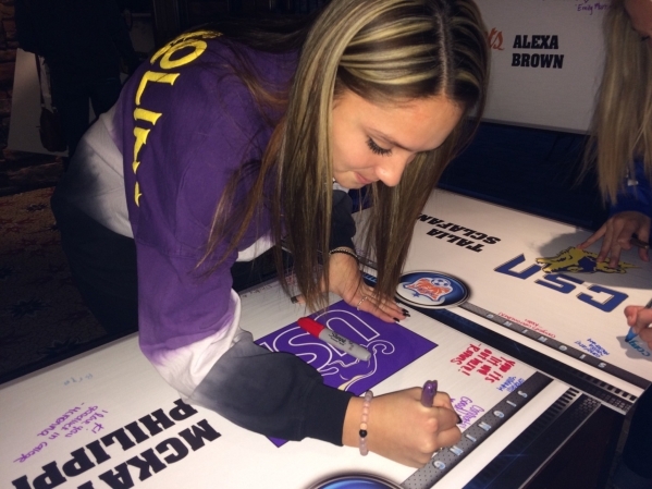 Audrina Krohn, 18, who attends College of Southern Nevada High School, signs her name to a banner Feb. 3 in the lobby of the Red Rock Country Club. She said she was not surprised that so many stud ...