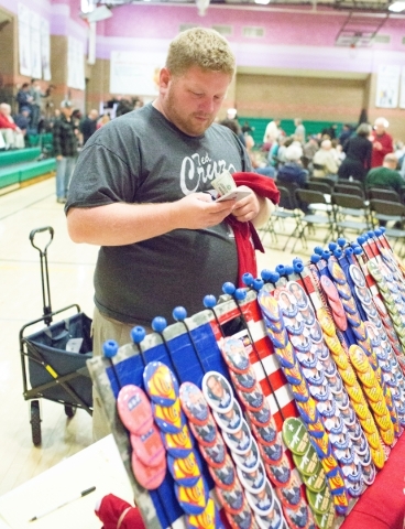 Michael Goodart, a vendor, sells buttons and t-shirts to attendees prior to the start of a rally for Republican presidential candidate U.S. Sen. Ted Cruz, R-Texas, at Durango Hills Community Cente ...