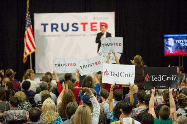 Supporters raise their posters while Republican presidential candidate U.S. Sen. Ted Cruz, R-Texas, speaks at a rally at Durango Hills Community Center, 3521 N. Durango Dr., in Las Vegas Monday, F ...