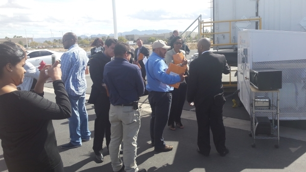 Guests of Thursday‘s local unveiling of the Solar Cold Box talk with representatives of Aldelano Corp. in the parking lot of the Switch Innevation Center in Las Vegas on Feb. 18, 2016.  Rich ...