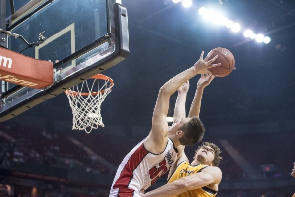 UNLV forward Stephen Zimmerman Jr. (33) goes to the net while being defended by Wyoming center Jonathan Barnes (21) during the first half at the Thomas & Mack Center in Las Vegas on Saturday,  ...