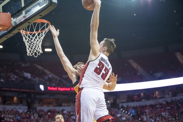 UNLV forward Stephen Zimmerman Jr. (33) dunks the ball over Wyoming center Jonathan Barnes (21) during the first half at the Thomas & Mack Center in Las Vegas on Saturday, Feb. 27, 2016. Joshu ...