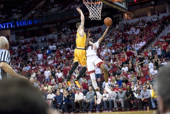 UNLV forward Derrick Jones Jr. (1) is fouled by Wyoming guard Josh Adams (14) during the second half at the Thomas & Mack Center in Las Vegas on Saturday, Feb. 27, 2016. UNLV won 79-74. Joshua ...