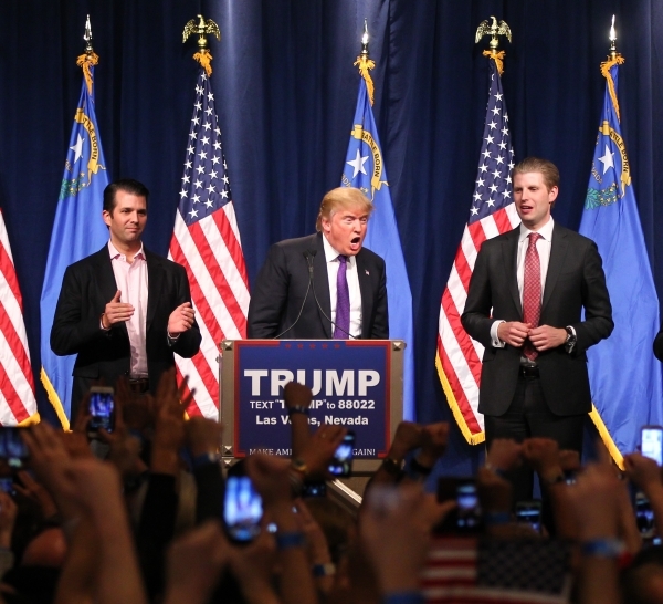 Republican presidential candidate Donald Trump, flanked by sons Donald Trump Jr., left, and Eric Trump, speaks at his watch party at Treasure Island hotel-casino in Las Vegas on Tuesday, Feb. 23,  ...