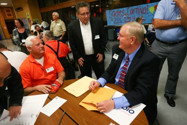 Caucus-goers, from left Clay Werts, Stephen Kopolow and Bill Harrington discuss Republican presidential candidates at Bonanza High School in Las Vegas on Tuesday, Feb. 23, 2016. Chase Stevens/Las  ...