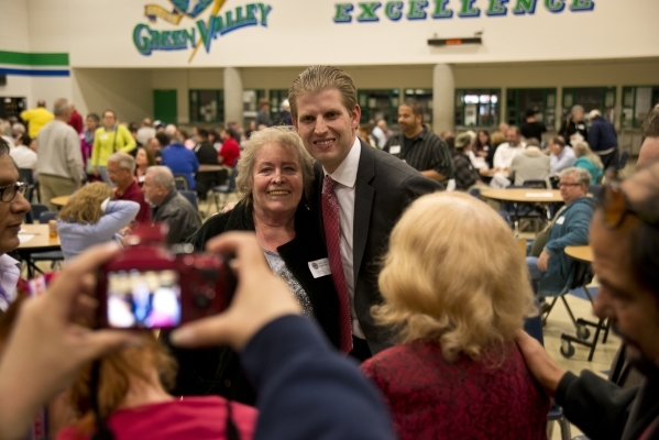 Eric Trump, the son of GOP presidential candidate Donald Trump, takes a photo with Barbara Ryan inside Green Valley High School during the Nevada Republican presidential caucus in Henderson on Tue ...