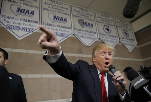 Republican U.S. presidential candidate Donald Trump addresses caucus goers as he visits a Nevada Republican caucus site at Palo Verde High School in Las Vegas, Nevada February 23, 2016.    REUTERS ...