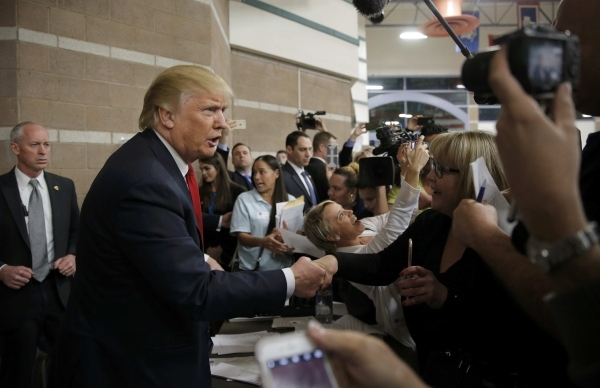 Republican U.S. presidential candidate Donald Trump greets caucus goers as he visits a Nevada Republican caucus site at Palo Verde High School in Las Vegas, Nevada February 23, 2016.    REUTERS/Ji ...