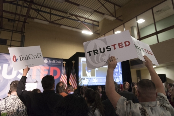 Signs are raised above the crowd at the GOP caucus watch party for presidential candidate Ted Cruz at the Bill & Lillie Heinrich YMCA at 4141 Meadows Lane in Las Vegas Tuesday, Feb. 23, 2016.  ...