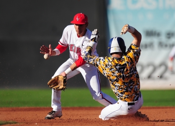 UNLV shortstop Nick Rodriguez is unable to catch an off-target throw as West Virginia base runner KC Huth steals second base in the sixth inning of their NCAA college Baseball game at Earl E. Wils ...