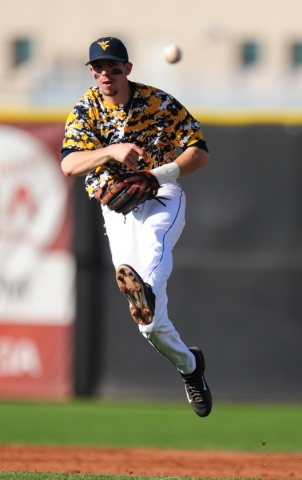 West Virginia shortstop Jimmy Galusky throws out a UNLV base runner at first base in the fourth inning of their NCAA college Baseball game at Earl E. Wilson Stadium in Las Vegas Saturday, Feb. 27, ...