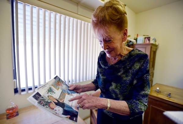 Town founder Nancy Kidwell looks over some photographs in her office at the Cal-Nev-Ari Casino on Thursday, Feb. 25, 2016, in Cal-Nev-Ari. Kidwell together with her late husband, Slim Kidwell acqu ...