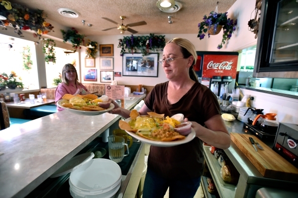 Waitress Jennifer Schumacher delivers two lunch specials at the Cal-Nev-Ari restaurant on Thursday, Feb. 25, 2016, in Cal-Nev-Ari. Schumacher has been working for Nancy Kidwell off and on for the ...