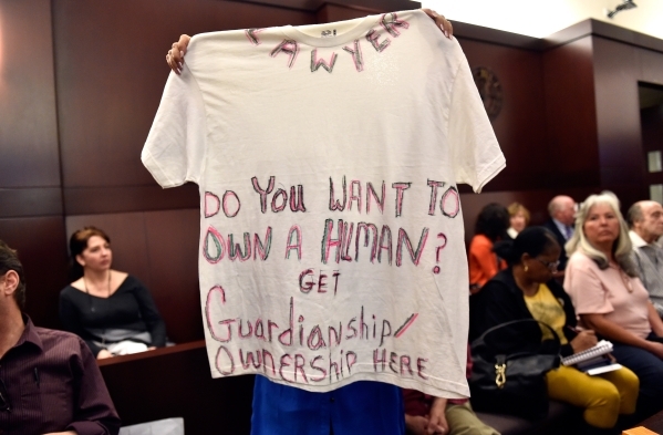 Fran Grady displays a message on a T-shirt before the start of the Nevada Supreme Court guardianship committee meeting at the Regional Justice Center Friday, Feb. 26, 2016. David Becker/Las Vegas  ...