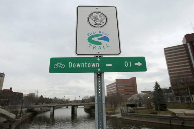 A Flint River sign is seen along the Flint river in Flint, Michigan in this December 16, 2015 file photo.   REUTERS/Rebecca Cook/Files
