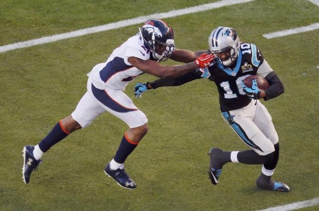 Denver Broncos' Aqib Talib (L) grabs Carolina Panthers' Corey