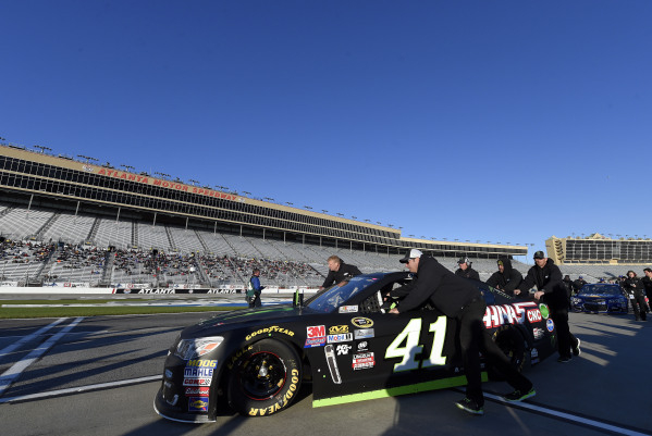 The crew of NASCAR Sprint Cup Series driver Kurt Busch (41) push his car onto the grid before qualifying for the Folds of Honor QuikTrip 500 at Atlanta Motor Speedway. Mandatory Credit: John David ...