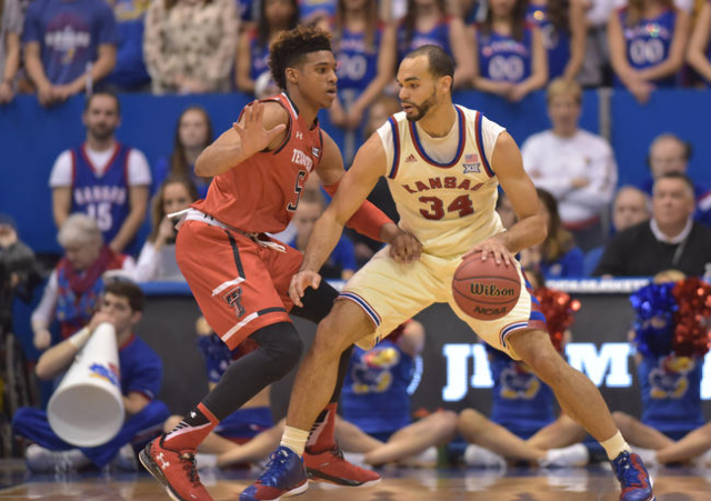 Kansas Jayhawks forward Perry Ellis (34) dribbles the ball as Texas Tech Red Raiders forward Justin Gray (5) defends during the first half at Allen Fieldhouse. The Jayhawks won 67-58, winning thei ...