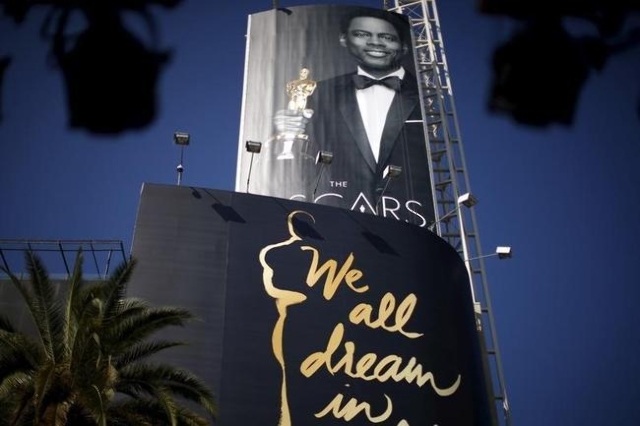 Oscars host Chris Rock is seen on a poster at the entrance to the Dolby Theatre red carpet on Hollywood Boulevard as preparations continue for the 88th Academy Awards in Hollywood, Los Angeles, Ca ...
