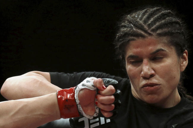 Jessica Aguilar of Mexico tries to skip a punch of Claudia Gadelha of Brazil during their Ultimate Fighting Championship (UFC) match, a professional mixed martial arts (MMA) competition in Rio de  ...
