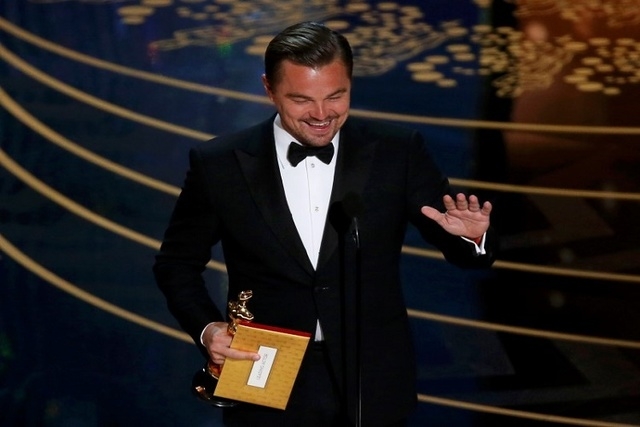 Leonardo DiCaprio accepts the Oscar for Best Actor for the movie "The Revenant" at the 88th Academy Awards in Hollywood, California February 28, 2016. (Reuters/Mario Anzuoni)