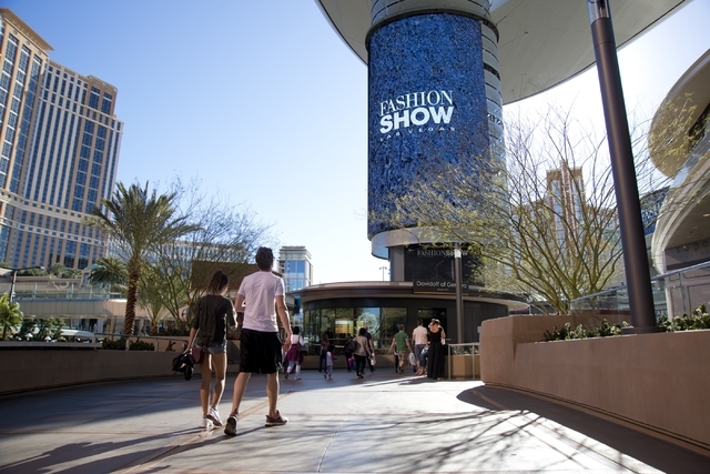 Visitors walk toward one of the massive screens recently added to the pillars underneath the "Cloud," a steel canopy at the Fashion Show Mall on the Las Vegas Strip on Thursday, ...