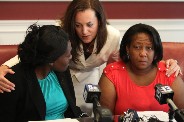 Nychele Thomas, left, and Angela Gilmore, right, mothers of two teenagers who died in a crash with drunk driver on March 5, are comforted by one of their attorneys, Heather Harris, following a pre ...