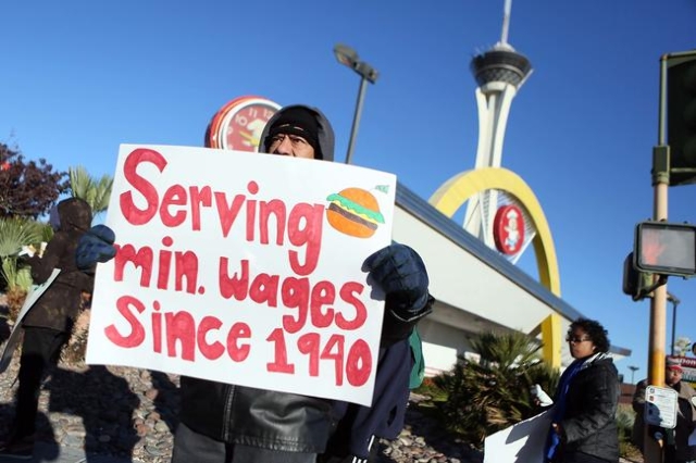 Cesar Torres holds a sign during a protest outside McDonald’s on 2248 Paradise Road Thursday, Dec. 5, 2013, in Las Vegas. Community members and fast-food workers gathered as part of a nation-wid ...