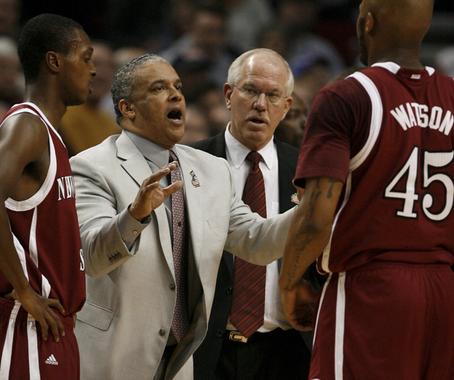 New Mexico State University coach Marvin Menzies (2nd L) gives instructions during a timeout in their men's NCAA basketball game against Indiana University in Portland, Oregon March 15, 2012. (Ste ...