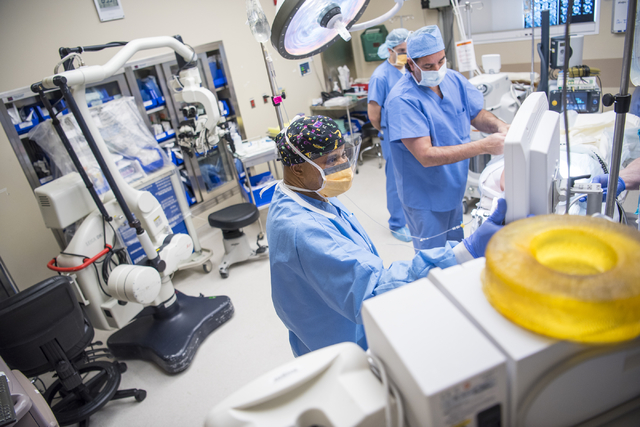 Samson Otuwa, physician anesthesiologist, left, monitors a patient's vitals as he preps him for surgery at University Medical Center in Las Vegas on Friday, Feb. 12, 2016. Joshua Dahl/Las Vegas Re ...