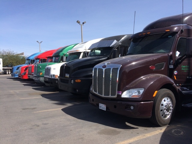 Big rigs are shown lined up March 15, 2016, at a Las Vegas truck stop. Such 18-wheelers can weigh 25 times more than a car, which means they need longer to stop. A car taveling 55 mph needs 265 fe ...