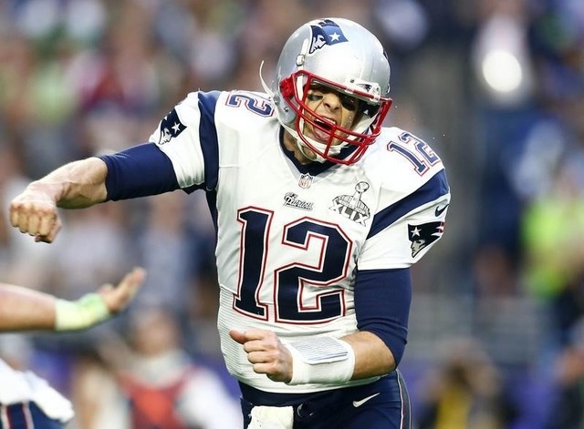 Feb 1, 2015; Glendale, AZ, USA; New England Patriots quarterback Tom Brady (12) celebrates after throwing a touchdown pass against the Seattle Seahawks in the second quarter in Super Bowl XLIX at ...