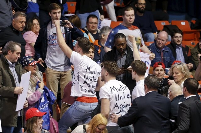 Protesters are escorted out of UIC Pavilion before Donald Trump's rally at the University of Illinois at Chicago on Friday. (Kamil Krzaczynski/Reuters)