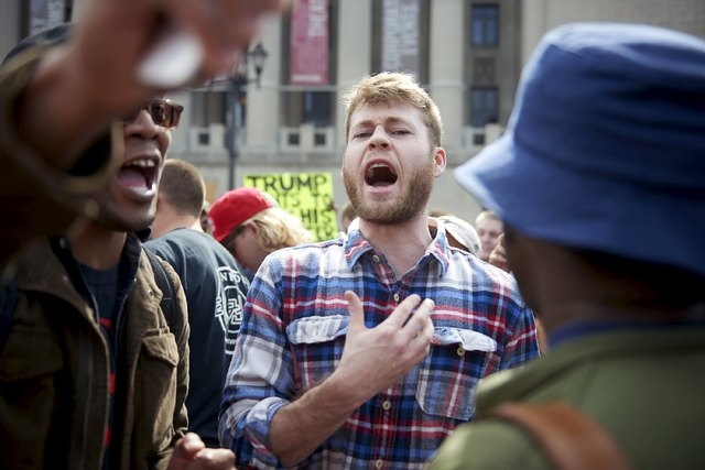 A supporter of Donald Trump argues with protesters against Trump outside the Peabody Opera House where Trump was to give a campaign speech in St. Louis on Friday. (Sara Swaty/Reuters)