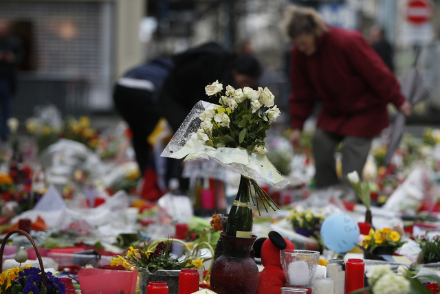 Tributes are left for the victims of the recent bomb attacks in Brussels in the Place de la Bourse in Brussels, Monday, March, 28, 2016. The Belgian health minister says four of those wounded in t ...