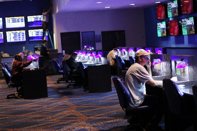Bettors watch races at the William Hill Sports Book at The Plaza in Las Vegas. (Review-Journal File Photo)
