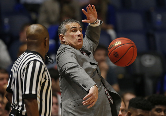 South Carolina head coach Frank Martin dodges a basketball as it sails out of bounds during the first half of an NCAA college basketball game against Georgia in the Southeastern Conference tournam ...