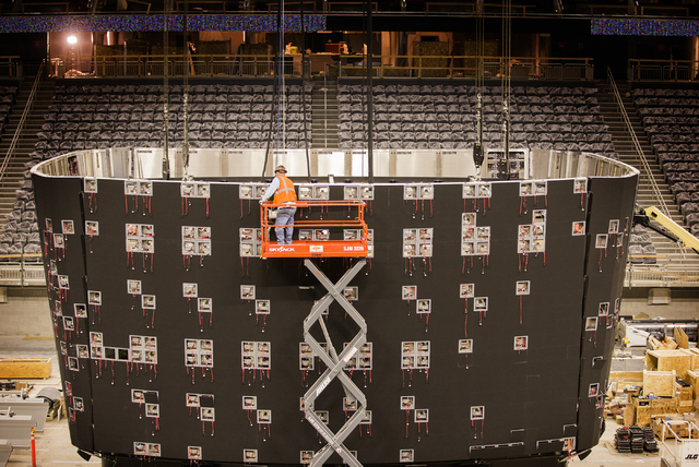 A man works on the T-Mobile Arena scoreboard behind New York-New York on Monday, Feb. 29, 2016. The joint venture partners AEG and MGM Resorts is scheduled to open the arena next month. Jeff Schei ...