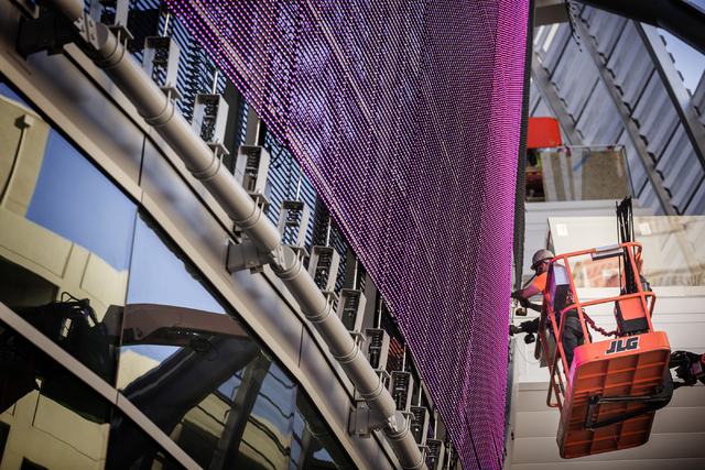 Men install lighting on the 209-foot-by-45 foot digital board on the T-Mobile Arena behind New York-New York on Monday, Feb. 29, 2016. The joint venture partners AEG and MGM Resorts are scheduled ...