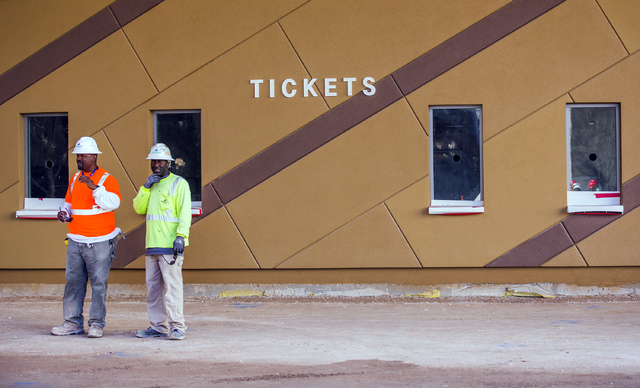 Workers stand near the ticket windows at the T-Mobile Arena behind New York-New York on Monday, Feb. 29, 2016. The joint venture partners AEG and MGM Resorts is scheduled to open the arena next mo ...