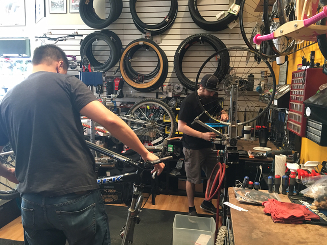 Mike Skoy, left, and Chris Bernardi work on bicycles inside The Vault Bicycle Shop, 7575 Norman Rockwell Lane, No. 120, Feb. 24. Sandy Lopez/View