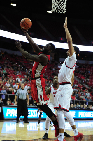 UNLV guard Ike Nwamu (34) goes up for a shot against Fresno State guard Cullen Russo in the first half of their Mountain West Conference semifinal basketball game at the Thomas & Mack Center i ...