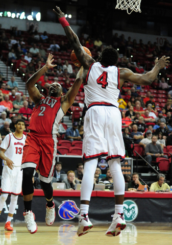 UNLV guard Jerome Seagears (2) fouls Fresno State forward Karacgi Edo (4) in the second half of their Mountain West Conference semifinal basketball game at the Thomas & Mack Center in Las Vega ...