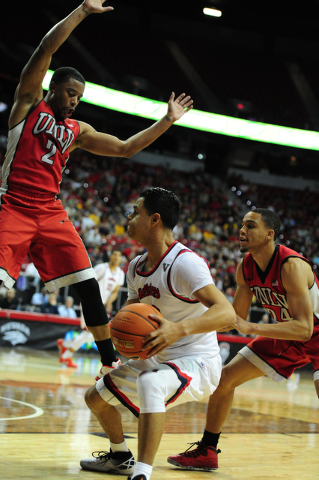 UNLV guards Jerome Seagears (2) and Jalen Poyser (24) defend Fresno State guard Cezar Guerrero (12) in the second half of their Mountain West Conference semifinal basketball game at the Thomas &am ...