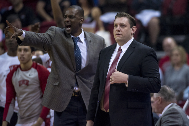 UNLV assistant coach Stacey Augmon, left, and UNLV head coach Todd Simon look on while playing the UNLV Rebels during the first half at the Thomas & Mack Center in Las Vegas on Saturday, Feb.  ...
