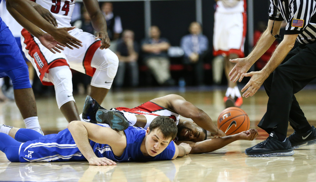 UNLV Rebels guard Jerome Seagears (2) falls on top of Air Force Falcons guard Daniel Hummer (4), who fouled Seagers, during the Mountain West Conference basketball tournament at the Thomas & M ...