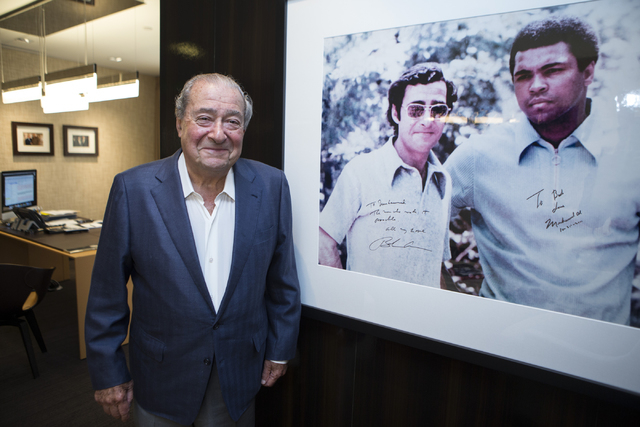Bob Arum, founder and CEO of Top Rank boxing promotions, poses for a portrait next to a photo of him and boxing legend Muhammad Ali at the Top Rank headquarters on Wednesday, March 23, 2016, in La ...