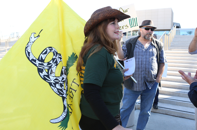 Kim Harris of Orange County, Calif., left, and Doug Knowles, right, protest outside Lloyd George Federal Building on Thursday, March 10, 2016, in Las Vegas. Cliven Bundy appears in court this afte ...