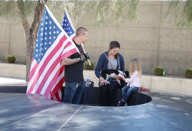 Brian Enright, left, his wife, Leslie, their daughter, Marine, 4, and their dog, Mia, rest after protesting outside Lloyd George Federal Building on Thursday, March 10, 2016, in Las Vegas. Cliven  ...