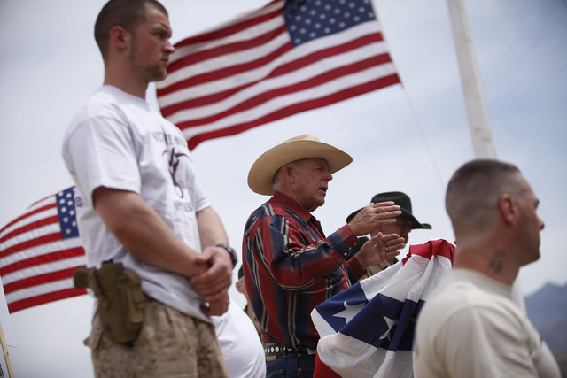 Flanked by armed supporters, Cliven Bundy speaks at a protest camp near Bunkerville, Nev. Friday, April 18, 2014. (John Locher/Las Vegas Review-Journal)